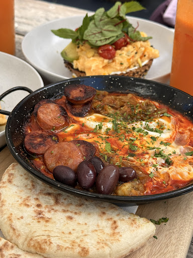 Shakshuka with olives and pita
